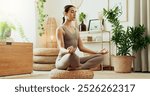 Girl, meditation and yoga at house for fitness zen, mindfulness development and lotus pose. Woman, relax and exercise with chakra energy, mental health peace and healing balance for self care