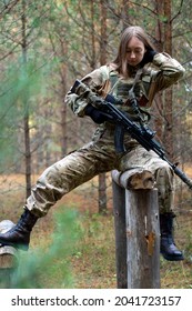 A Girl In Military Equipment Passes An Obstacle Course In A Forest Camp At An Army Training Ground.