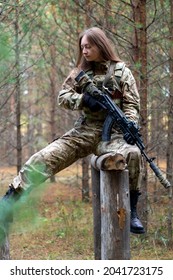 A Girl In Military Equipment Passes An Obstacle Course In A Forest Camp At An Army Training Ground.