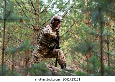 A Girl In Military Equipment Passes An Obstacle Course In A Forest Camp At An Army Training Ground.