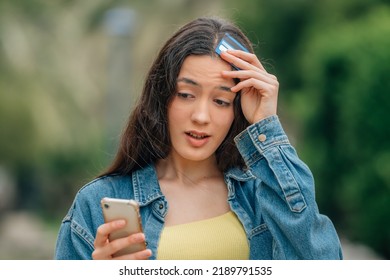 Girl With Mobile Phone And Credit Card And Forget The Password Or Forgetfulness