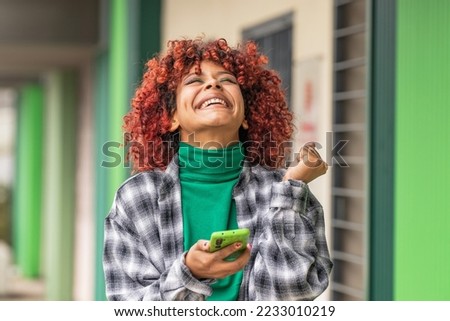 girl with mobile phone or smartphone and expression of success