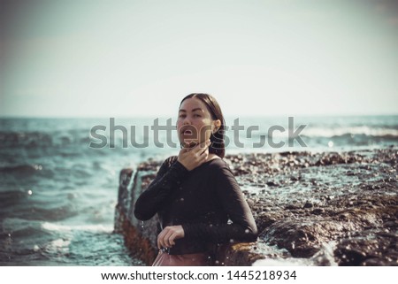 Similar – Beautiful young photographer woman wearing black clothes, sitting on the floor in countryside with her camera