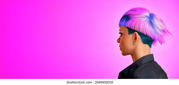 A girl with a modern asymmetrical hairstyle on a purple background