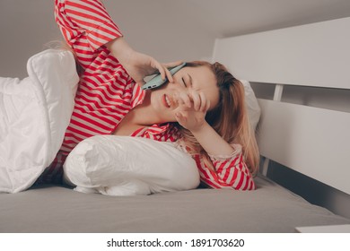 The Girl In The Morning Speaks On The Phone In Bed And Is Angry, Did Not Get Enough Sleep, Bad Dream. The Woman Does Not Want To Go To Work, Wake Up, Take Calls.