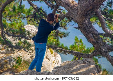 Girl In Navy Blue Hoodie And Jeans Admiring The Mountain Landscape