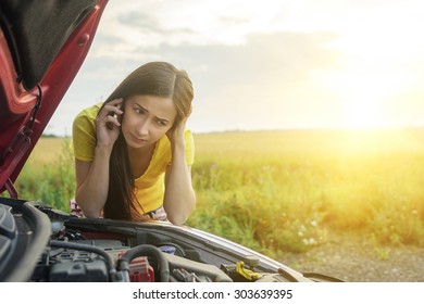 Girl Near A Broken Car On The Country Road Is Calling On Mobile Phone.