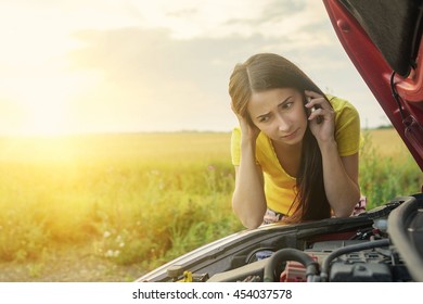 Girl Near A Broken Car On The Country Road Is Calling On Mobile Phone.