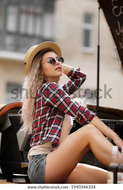 Girl near a retro car\
making coffee