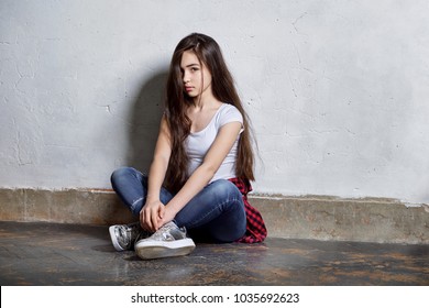 girl near wall. Girl brunette asian. fashion hipster teen. sits floor. Stylish fashion teenager clothed in casual clothes. fashion concept.