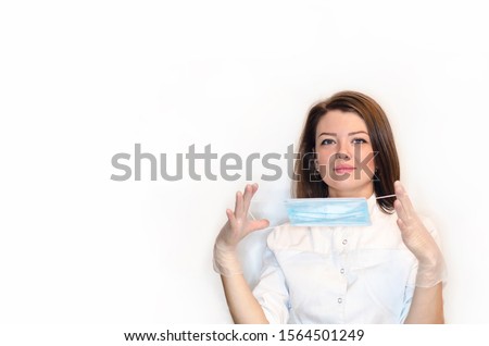 girl nurse, woman, lady doctor in white coat, sterile white latex gloves puts on mask for procedure, operation. health care. medical concept and beauty. copy space,  virus, epidemic, safety, 
