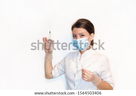 girl nurse, young woman, lady doctor in white coat, sterile white latex gloves, mask holds syringe for injection, vaccination, pain relief. health care. medical concept. virus, epidemic, safety, 