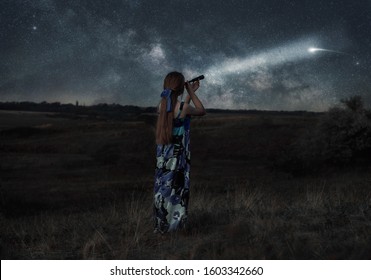 
Girl Observes the stars through a telescope. Shooting star