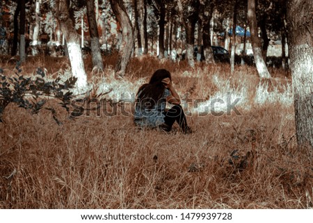 Similar – a girl with long hair and blue eyes in the mountain covering her face with her hair