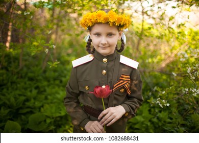 Girl in old military uniform. Background