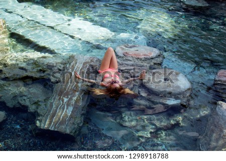 girl in an old pool with columns
