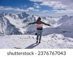 Girl on the background of snow-capped mountains. Caucasian mountains. Elbrus. Russia. April 25, 2019
