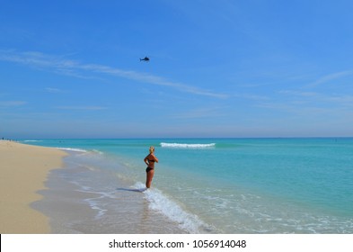 Girl on the beach looking at the helicopter, Miami, Florida, Haulover beach