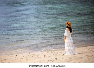 A girl on the beach in a sad mood,
The woman with the sea in the evening