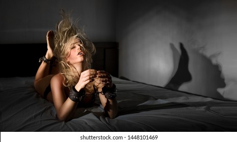 The Girl On The Bed Is Handcuffed. BDSM.