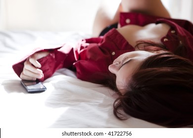Girl on bed with mobile phone