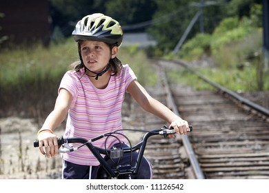 Girl On A Bike Along Train Tracks, Taking A Shortcut Home From School