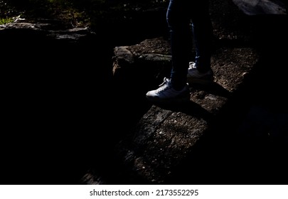 Girl On The Edge Of Cliff In Stone.Dark And Gloomy Mood.