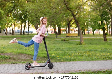 girl on an electronic scooter in a city park in the summer - Powered by Shutterstock