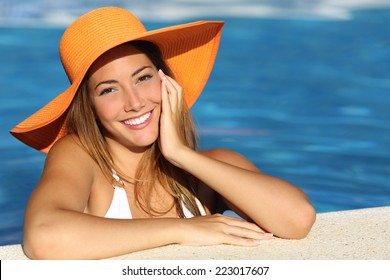 Girl on holidays with a perfect white smile bathing in a pool on vacations - Powered by Shutterstock