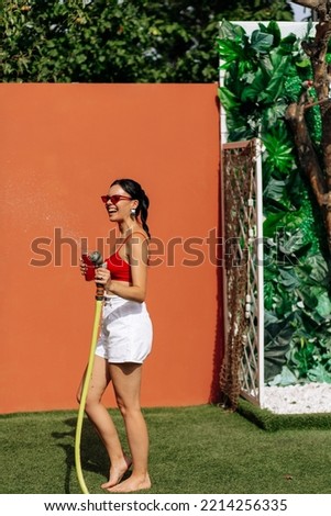 Similar – Young surfer woman with top and bikini kissing surfboard