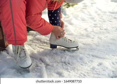 Girl On The Rink Lacing Skates For Figure Skating. Close Up. Winter Lake.