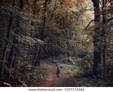 Similar – Image, Stock Photo Young woman with hat taking a walk in the deep forest at sunset.