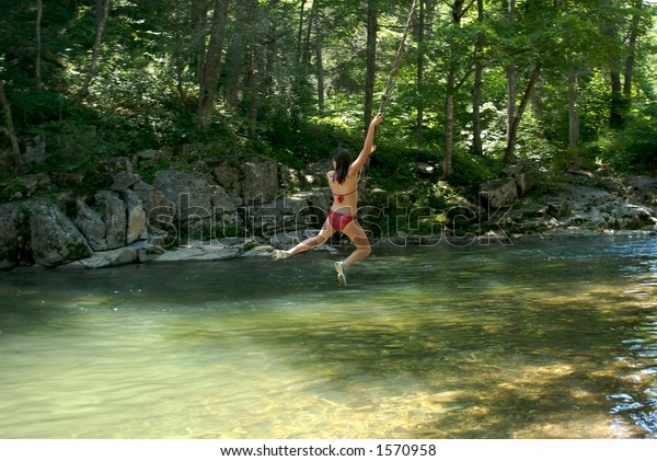 Girl On Rope Swing Over River Stock Photo Edit Now 1570958