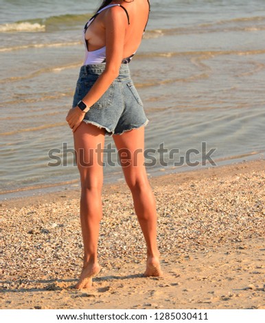 Similar – Young, long-legged, slim woman on the beach