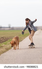 Girl On Skateboard With A Dog At The Leash