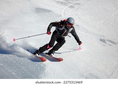Girl On the Ski. Active winter holidays, skiing downhill in sunny day. Woman skier - Shutterstock ID 2275313469