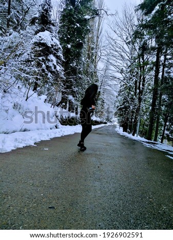 Image, Stock Photo Girl waiting at the side of the snowy mountain road looking down