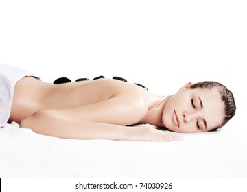 Girl on a stone therapy, hot stone massage. Isolated on white.
