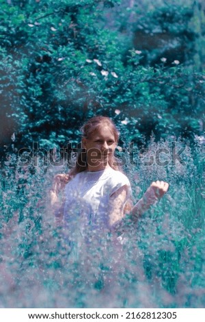 Similar – eine frau vor  einer blumenwiese. blumen pflücken