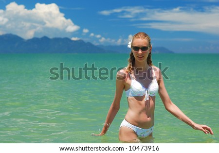 Girl on a tropical beach in the sea