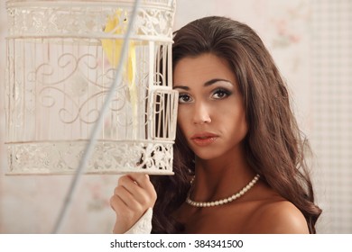 Girl On A Vintage Dress Possing With Birdcage Studio