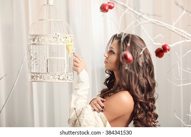 Girl On A Vintage Dress Possing With Birdcage Studio