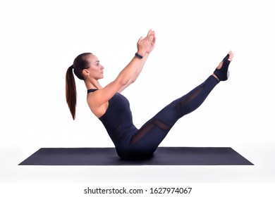 Girl on a white background does a teaser exercise. Yoga. Pilates. Healthy lifestyle concept