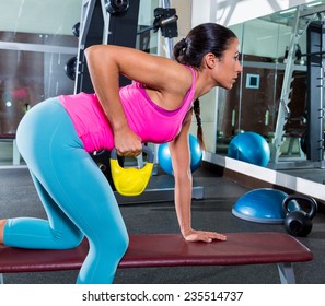 Girl One Arm Kettlebell Bent Over Row On Bench Workout Exercise At Gym