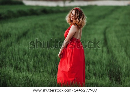 girl with open neckline; beautiful girl in a red light dress;
open and light dress on a curly girl

