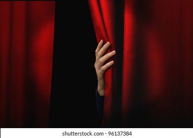 Girl open a red curtain
