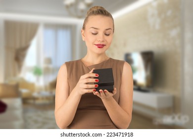 girl opens a box with a gift - Shutterstock ID 223471918