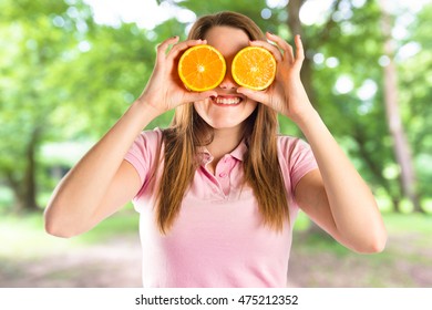 She likes oranges. Девушка с апельсинами. Девушка с апельсинами вместо глаз. Девушка держит апельсин. Апельсин в руке девушки.