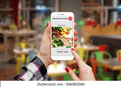Girl Ordering Food With Smartphone App In Restaurant