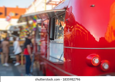 Girl ordering street food in colourful food truck van on food festival, summer sunny day - Powered by Shutterstock